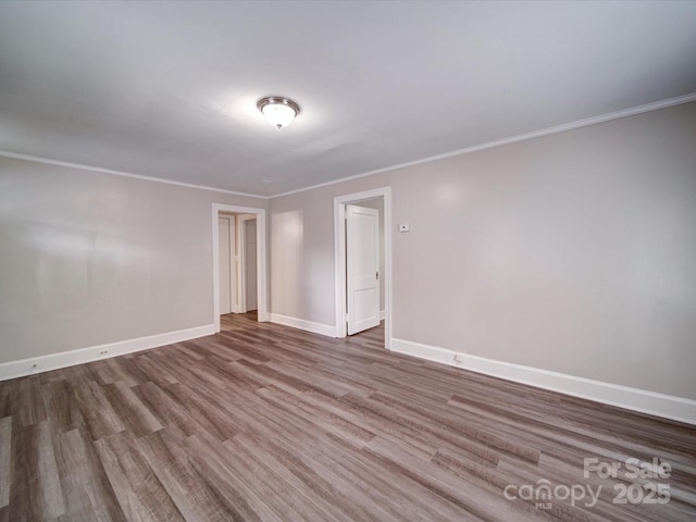 121 Patrick St, Gastonia, NC 28054 - empty room featuring wood finished floors, crown molding, and baseboards