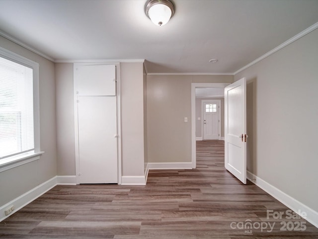 121 Patrick St, Gastonia, NC 28054 - unfurnished bedroom with wood finished floors, ornamental molding, baseboards, and a closet