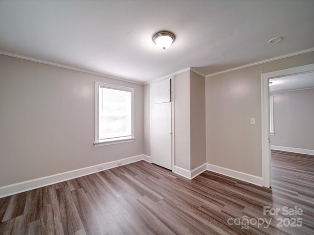 121 Patrick St, Gastonia, NC 28054 - unfurnished bedroom with wood finished floors, crown molding, baseboards, and a closet