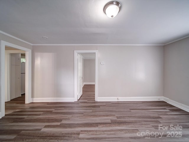 121 Patrick St, Gastonia, NC 28054 - empty room with baseboards, crown molding, and wood finished floors