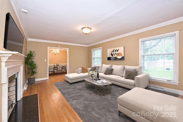 1961 Runnymede Ln, Charlotte, NC 28211 - living room with a chandelier, crown molding, wood finished floors, baseboards, and a fireplace