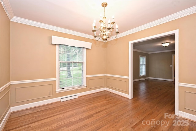 1961 Runnymede Ln, Charlotte, NC 28211 - spare room featuring a chandelier, healthy amount of natural light, wood finished floors, ornamental molding, and a wainscoted wall
