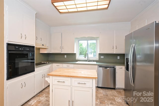 1961 Runnymede Ln, Charlotte, NC 28211 - kitchen featuring black appliances, a sink, stone finish floors, ornamental molding, and butcher block counters