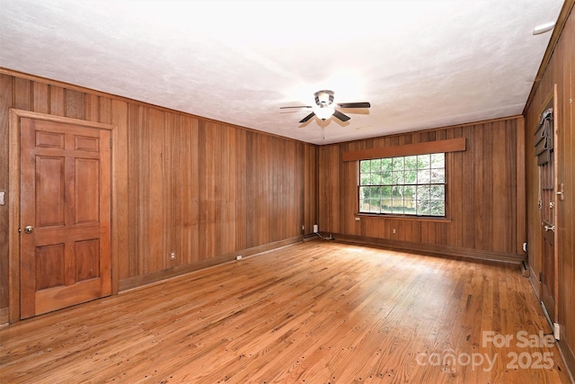 1961 Runnymede Ln, Charlotte, NC 28211 - unfurnished room with a ceiling fan, light wood finished floors, wooden walls, and baseboards