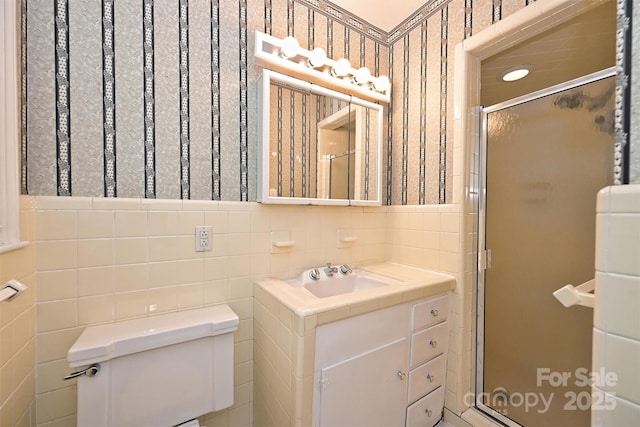 1961 Runnymede Ln, Charlotte, NC 28211 - full bath featuring toilet, a shower stall, tile walls, vanity, and wallpapered walls