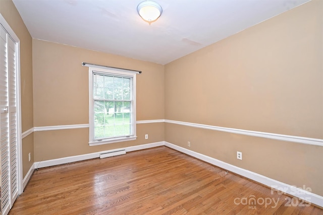 1961 Runnymede Ln, Charlotte, NC 28211 - unfurnished room with wood finished floors, baseboards, and a baseboard heating unit