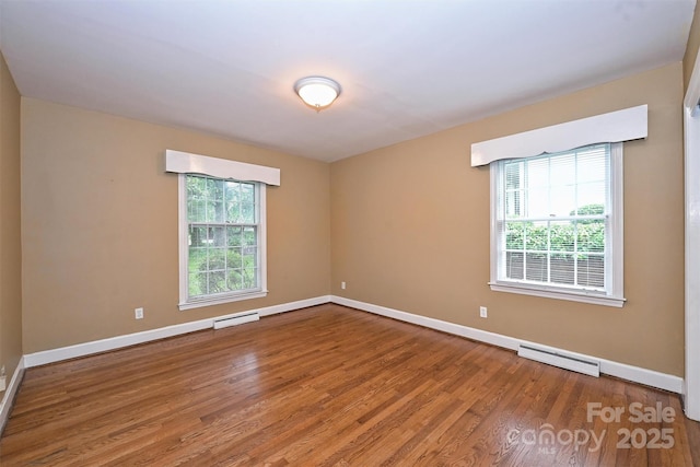 1961 Runnymede Ln, Charlotte, NC 28211 - unfurnished room featuring a baseboard radiator, wood finished floors, plenty of natural light, and baseboards
