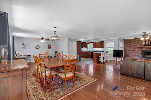 2010 Dogwood Trl, Shelby, NC 28150 - dining space featuring ceiling fan, a fireplace, light wood finished floors, crown molding, and recessed lighting