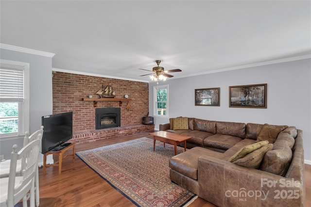 2010 Dogwood Trl, Shelby, NC 28150 - living room featuring wood finished floors, ornamental molding, ceiling fan, a brick fireplace, and baseboards