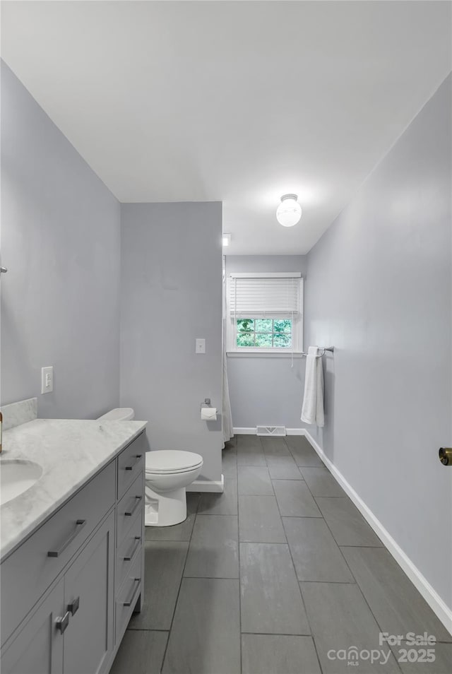 2010 Dogwood Trl, Shelby, NC 28150 - bathroom featuring vanity, toilet, baseboards, and tile patterned flooring