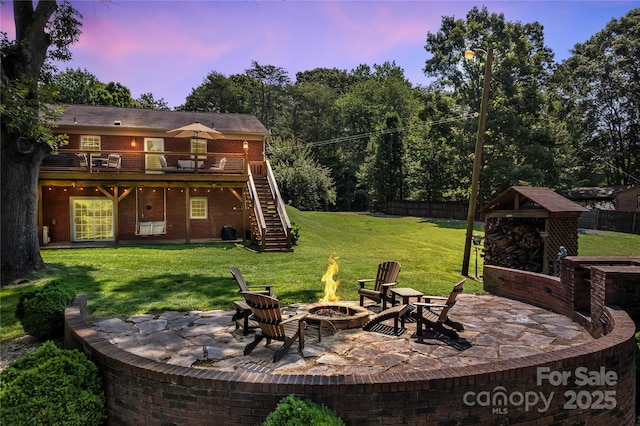 2010 Dogwood Trl, Shelby, NC 28150 - yard at dusk with a fire pit, a deck, stairway, and a patio area