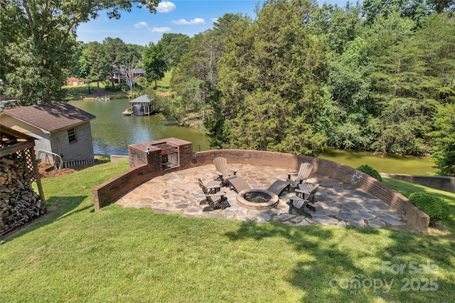 2010 Dogwood Trl, Shelby, NC 28150 - view of green lawn featuring an outdoor fire pit, a patio area, and a water view