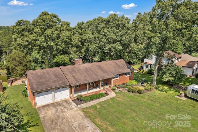 2010 Dogwood Trl, Shelby, NC 28150 - view of front of home featuring a porch, a front lawn, concrete driveway, and a chimney