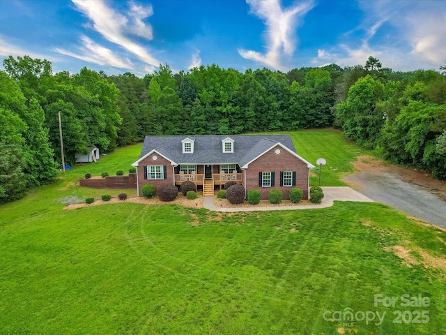 1060 S Lentz Harness Shop Rd, Mount Pleasant, NC 28124 - view of front of property with a front yard, a porch, brick siding, and a forest view