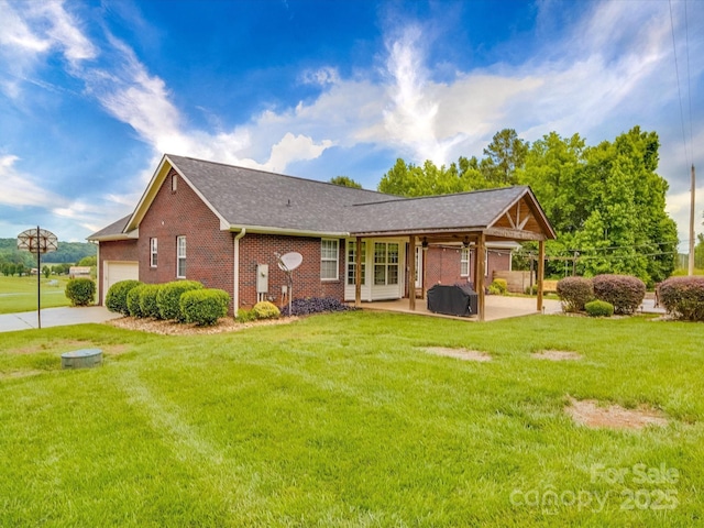 1060 S Lentz Harness Shop Rd, Mount Pleasant, NC 28124 - back of house with brick siding, a lawn, an attached garage, a patio area, and roof with shingles
