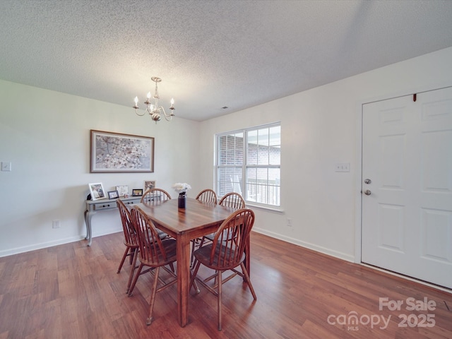 1060 S Lentz Harness Shop Rd, Mount Pleasant, NC 28124 - dining space featuring a chandelier, dark wood-style flooring, a textured ceiling, and baseboards