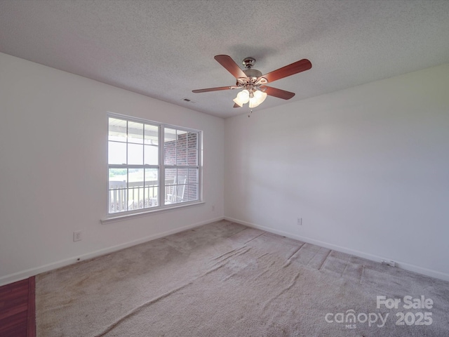 1060 S Lentz Harness Shop Rd, Mount Pleasant, NC 28124 - spare room featuring light colored carpet, a ceiling fan, baseboards, and a textured ceiling