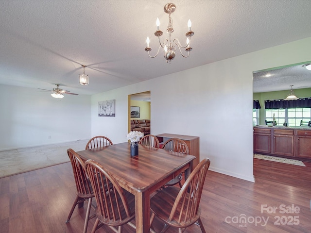 1060 S Lentz Harness Shop Rd, Mount Pleasant, NC 28124 - dining room featuring wood finished floors, a textured ceiling, ceiling fan, and a chandelier