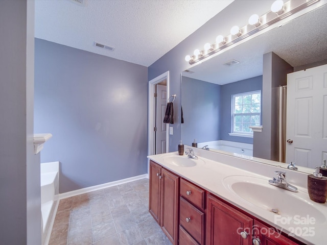 1060 S Lentz Harness Shop Rd, Mount Pleasant, NC 28124 - bathroom featuring a bath, double vanity, a textured ceiling, and baseboards