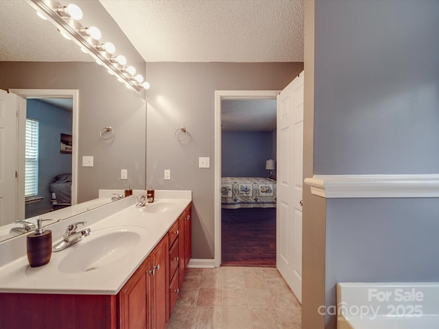 1060 S Lentz Harness Shop Rd, Mount Pleasant, NC 28124 - ensuite bathroom featuring double vanity, a textured ceiling, and baseboards