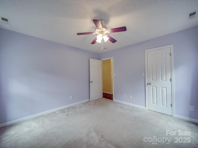 1060 S Lentz Harness Shop Rd, Mount Pleasant, NC 28124 - unfurnished bedroom featuring light colored carpet, baseboards, a ceiling fan, and a textured ceiling