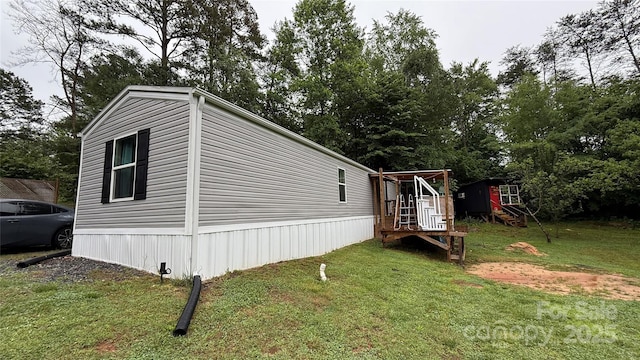 143 Hamilton Rd, Rutherfordton, NC 28139 - view of property exterior featuring a lawn, stairs, and view of wooded area