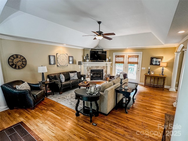 3273 16th St NE, Hickory, NC 28601 - living room with ceiling fan, a tray ceiling, wood finished floors, a tiled fireplace, and decorative columns