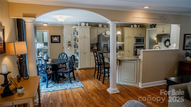 3273 16th St NE, Hickory, NC 28601 - dining room featuring ornate columns, arched walkways, light wood-style flooring, crown molding, and recessed lighting