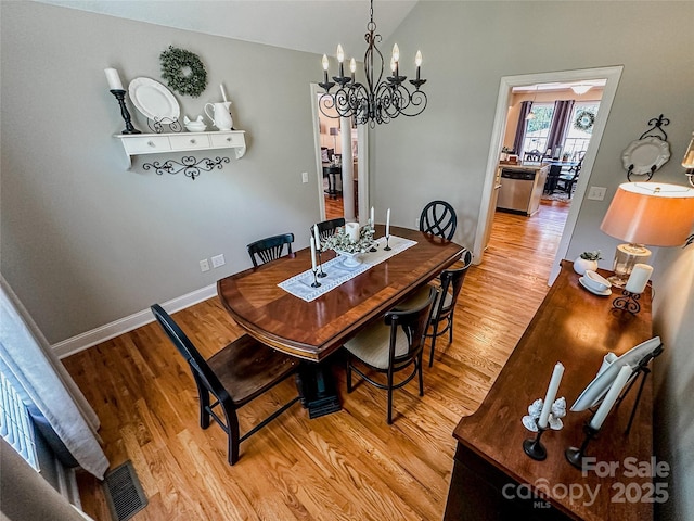 3273 16th St NE, Hickory, NC 28601 - dining area with a chandelier, light wood-style flooring, lofted ceiling, and baseboards