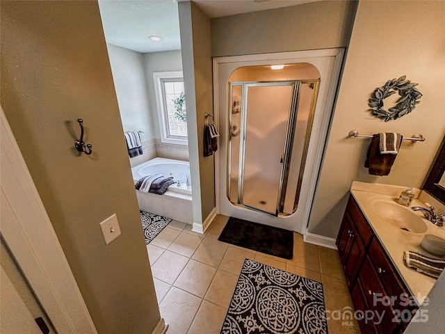 3273 16th St NE, Hickory, NC 28601 - bathroom featuring a stall shower, vanity, a bath, tile patterned flooring, and baseboards
