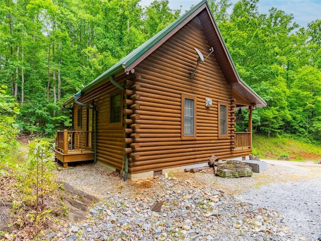 125 Cypress Ln, Saluda, NC 28773 - view of property exterior featuring log siding and a view of trees