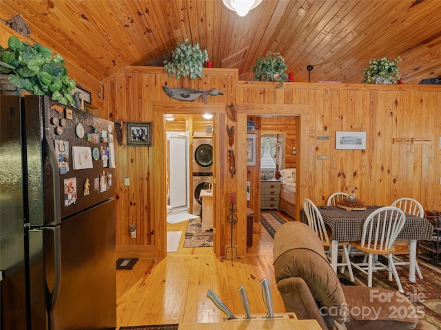 125 Cypress Ln, Saluda, NC 28773 - dining area with stacked washing machine and dryer, wood walls, hardwood / wood-style flooring, wood ceiling, and vaulted ceiling
