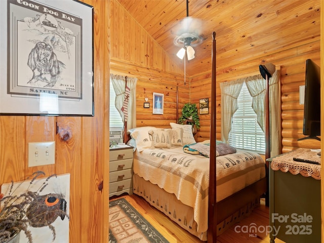 125 Cypress Ln, Saluda, NC 28773 - bedroom with log walls, wood finished floors, wood ceiling, and lofted ceiling