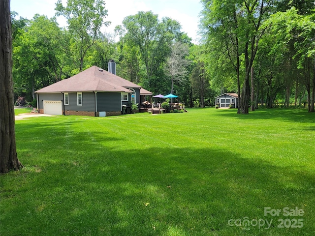 2777 Old S Ct NW, Concord, NC 28027 - view of green lawn with a garage, an outdoor structure, and driveway