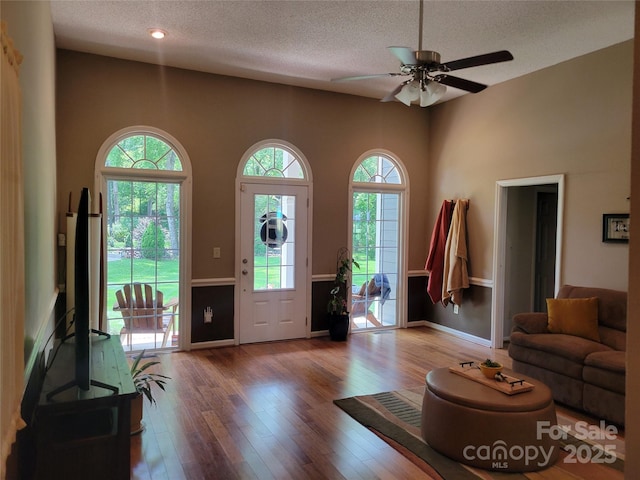 2777 Old S Ct NW, Concord, NC 28027 - foyer featuring healthy amount of natural light, a textured ceiling, a ceiling fan, and wood-type flooring