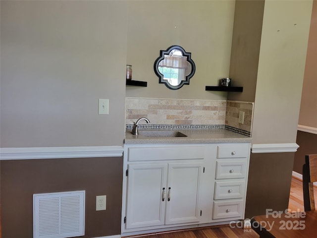 2777 Old S Ct NW, Concord, NC 28027 - kitchen with white cabinetry, light countertops, tasteful backsplash, and wood finished floors