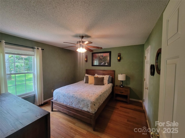 2777 Old S Ct NW, Concord, NC 28027 - bedroom featuring wood finished floors, a textured ceiling, and a ceiling fan