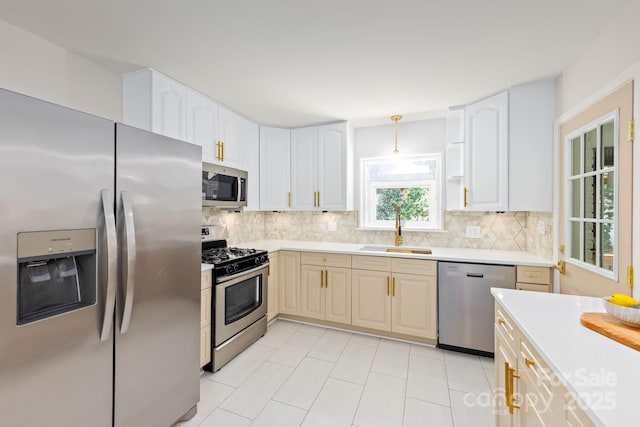 4913 Seacroft Rd, Charlotte, NC 28210 - kitchen featuring appliances with stainless steel finishes, backsplash, light countertops, light tile patterned floors, and decorative light fixtures