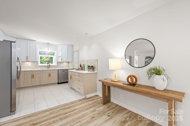4913 Seacroft Rd, Charlotte, NC 28210 - kitchen with stainless steel appliances, tasteful backsplash, light countertops, and light wood finished floors