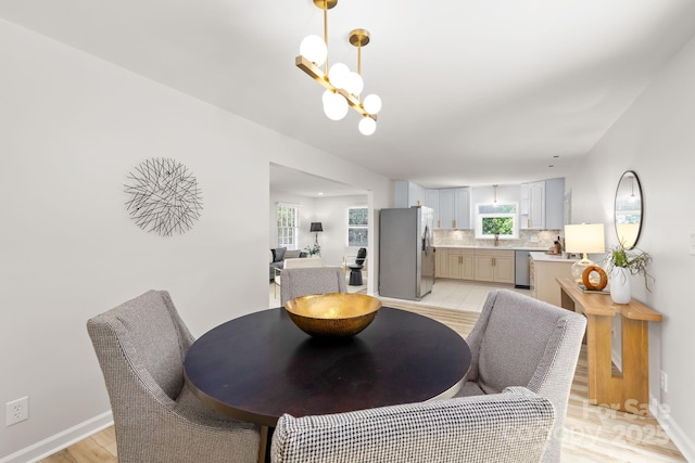 4913 Seacroft Rd, Charlotte, NC 28210 - dining area with light wood-style flooring and a chandelier
