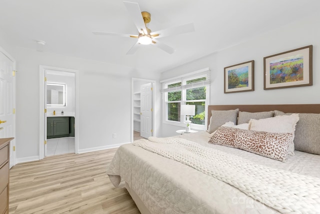 4913 Seacroft Rd, Charlotte, NC 28210 - bedroom featuring light wood-style flooring, a walk in closet, connected bathroom, and a ceiling fan