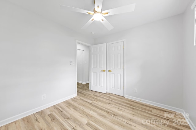 4913 Seacroft Rd, Charlotte, NC 28210 - unfurnished bedroom featuring light wood-style flooring, ceiling fan, and a closet