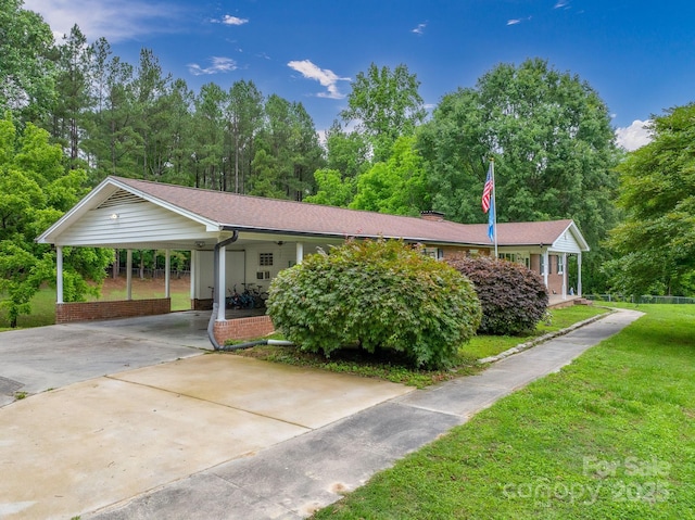 310 Yarbro Rd, Kings Mountain, NC 28086 - ranch-style house with a front yard, driveway, a carport, and brick siding