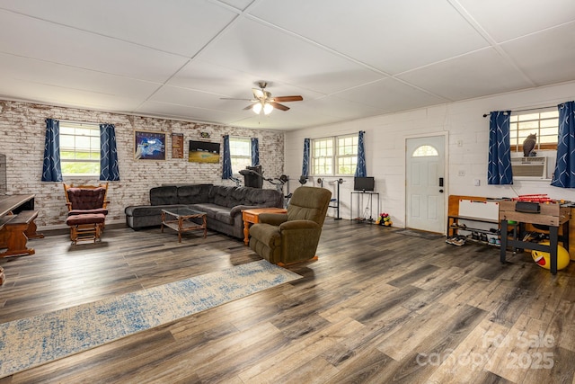 310 Yarbro Rd, Kings Mountain, NC 28086 - living area featuring wood finished floors, ceiling fan, healthy amount of natural light, brick wall, and a paneled ceiling