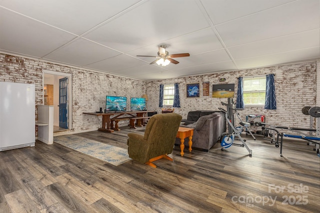 310 Yarbro Rd, Kings Mountain, NC 28086 - living room with brick wall, healthy amount of natural light, a ceiling fan, and wood finished floors