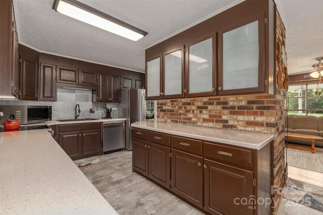 310 Yarbro Rd, Kings Mountain, NC 28086 - kitchen with stainless steel appliances, light countertops, a sink, a textured ceiling, and light wood-style floors