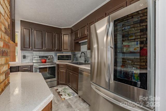 310 Yarbro Rd, Kings Mountain, NC 28086 - kitchen featuring stainless steel appliances, a sink, light countertops, backsplash, and dark brown cabinetry