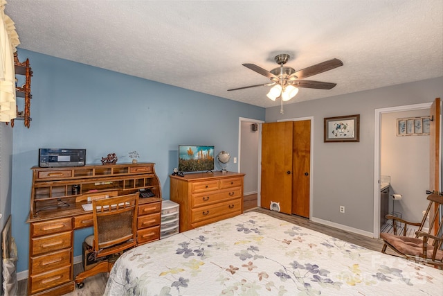310 Yarbro Rd, Kings Mountain, NC 28086 - bedroom featuring wood finished floors, baseboards, a textured ceiling, a ceiling fan, and ensuite bath