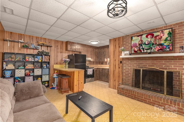 310 Yarbro Rd, Kings Mountain, NC 28086 - living room featuring a paneled ceiling, wood walls, and a fireplace