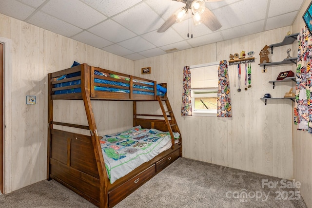310 Yarbro Rd, Kings Mountain, NC 28086 - bedroom featuring carpet, a drop ceiling, wood walls, and a ceiling fan